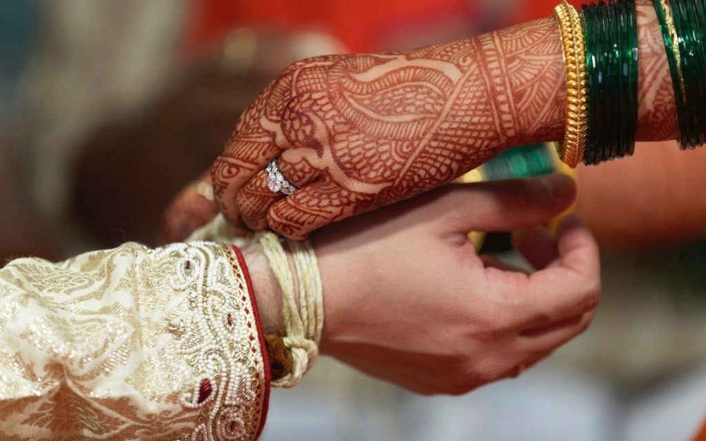 Indian hindu wedding, bride with mehendi-heena on her hand.