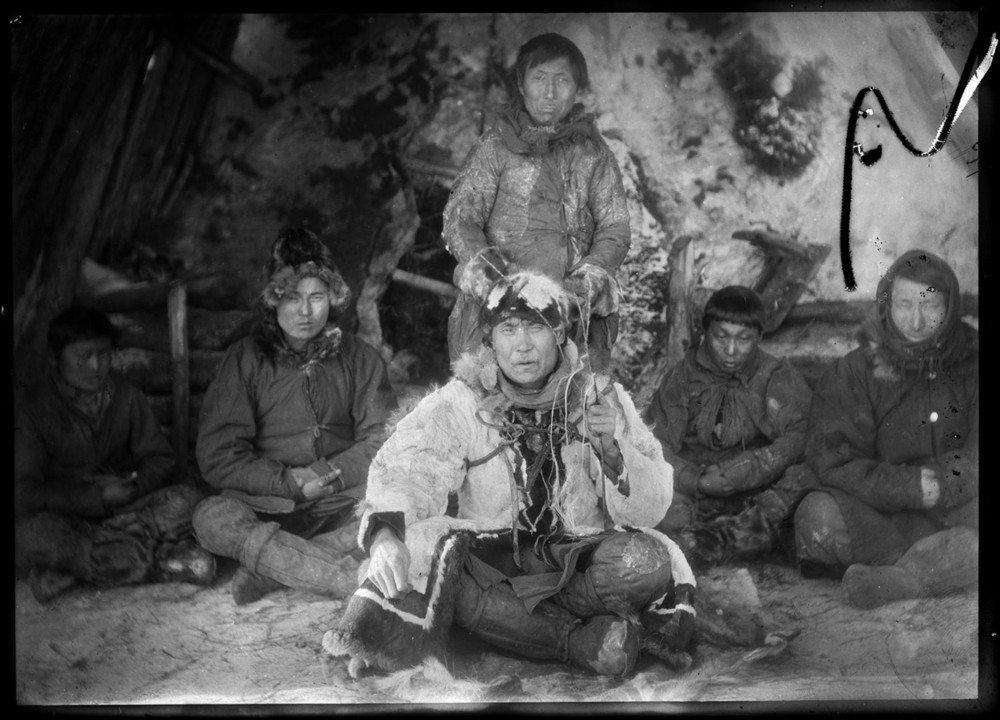 Yakut shaman sitting with men. © AMNH